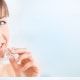 woman about to put in invisible (clear plastic) braces